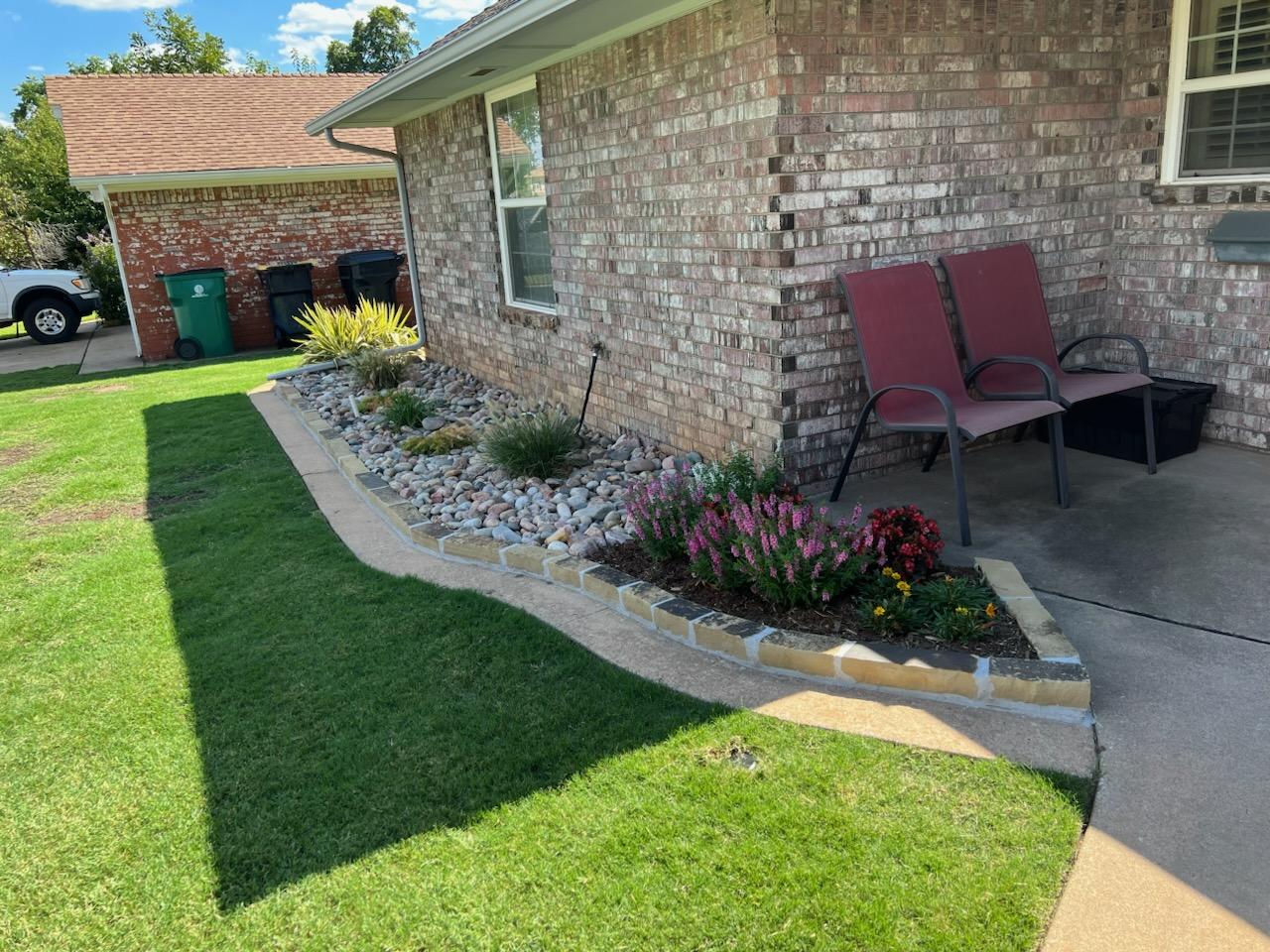 Completed landscaping and rock work near a house